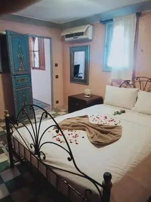 a bedroom with a large bed with flowers on it at Riad Wink in Marrakech
