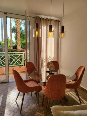 a dining room with a glass table and chairs at Oxygène in Marrakech