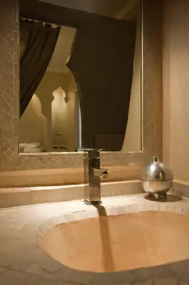 a sink in a bathroom with a mirror at Riad Cocoon in Marrakech
