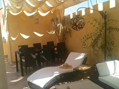 a dining room with a table and black chairs at Riad Cocoon in Marrakech