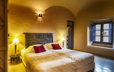 a bedroom with a large bed and a window at Caravan Serai in Douar Khalifa Ben Mbarek