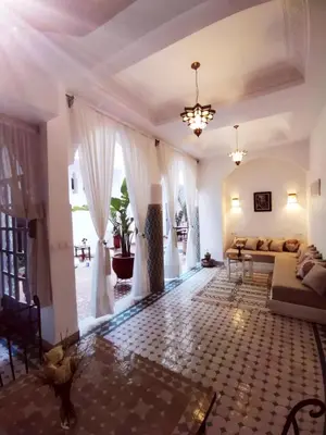 a living room with a couch and a table at Riad El Arco ROOFTOP POOL & Spa in Marrakech