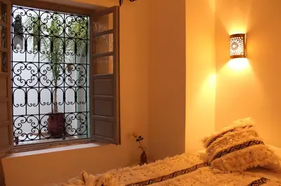a bedroom with a bed and a window at Riad El Arco ROOFTOP POOL & Spa in Marrakech