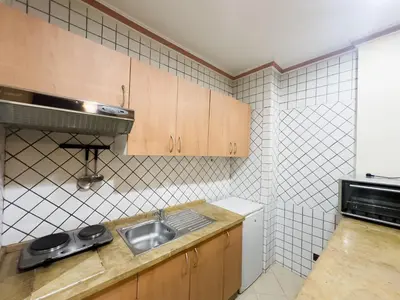 a small kitchen with a sink and a stove at Mogador Menzah Appart Hôtel in Marrakech