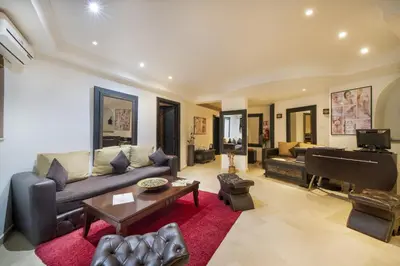 a living room with a couch and a piano at Mogador Menzah Appart Hôtel in Marrakech
