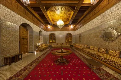 a large room with a large red rug in a building at Grand Mogador Menara & Spa in Marrakech