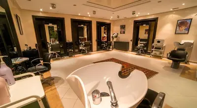 a hair salon with a tub and a lot of chairs at Grand Mogador Menara & Spa in Marrakech