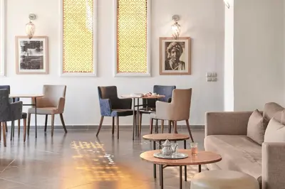 a living room with a couch and tables and chairs at Iberostar Waves Club Palmeraie Marrakech All Inclusive in Marrakech