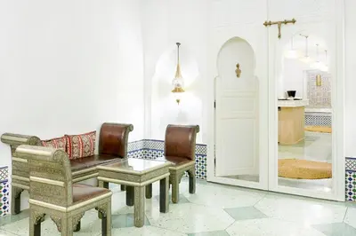 a living room with chairs and a bench and a table at Iberostar Waves Club Palmeraie Marrakech All Inclusive in Marrakech