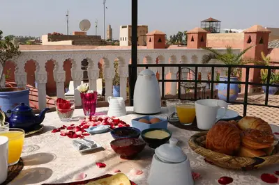 a table with food and drinks on top of a balcony at Riad Tahar Oasis in Marrakech
