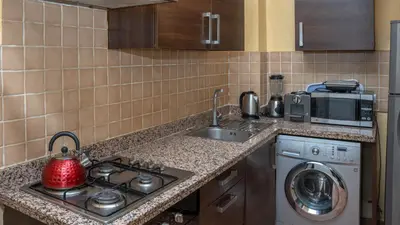 a kitchen with a sink and a washing machine at Appartements Marrakech Garden in Marrakech