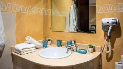 a bathroom with a sink and a mirror at Appartements Marrakech Garden in Marrakech