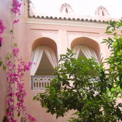 a building with two windows with pink flowers at Riad Sidi Omar in Marrakech