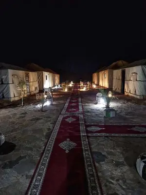 a group of tents with lights on a street at night at Riad Sidi Omar in Marrakech