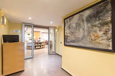 a hallway with a large painting on the wall at Hotel Almas in Marrakech