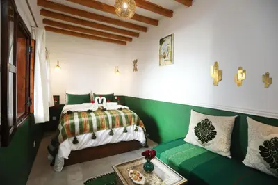 a bedroom with a bed and a couch at Riad Heklek in Marrakech