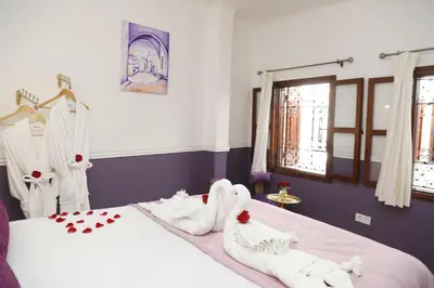 a bedroom with two beds with towels on them at Riad Heklek in Marrakech