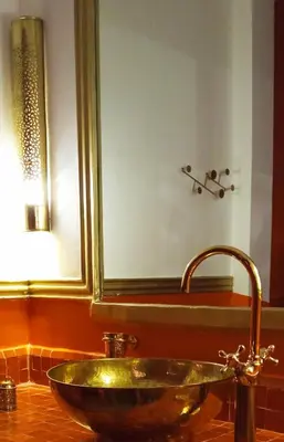 a bathroom with a sink and a large mirror at Riad Heklek in Marrakech