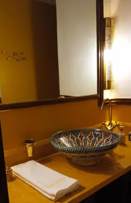 a bathroom with a bowl sink and a mirror at Riad Heklek in Marrakech