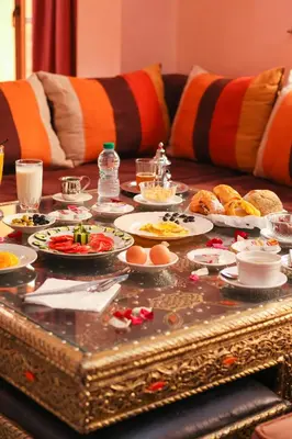 a table with plates of food on top of it at Hotel El Hadna By HMS in Marrakech