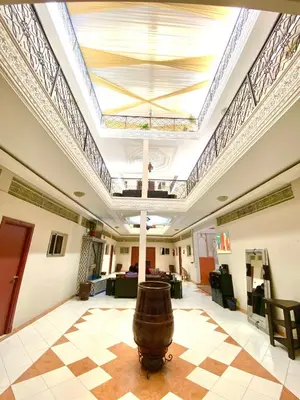 a large room with a ceiling with a large barrel in it at Hôtel Narjisse in Marrakech