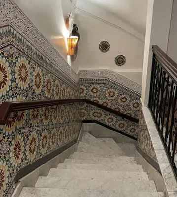 a staircase with colorful tiles on the wall at Hotel Riad Fantasia in Marrakech