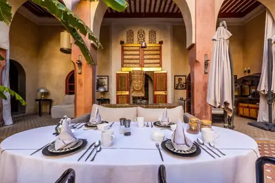 a table with a white table cloth in a room at Indian Palace in Marrakech