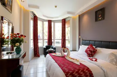 a bedroom with a bed with two swans on it at Hotel Akabar in Marrakech