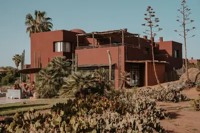 a house in the desert with plants in front of it at Fellah Hotel in Marrakech
