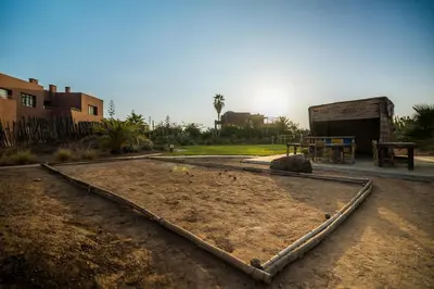 a dirt area with a picnic table and a building at Fellah Hotel in Marrakech