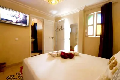 a bedroom with a bed with two towels on it at Riad Makech in Marrakech