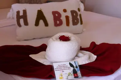 a hello kitty towel on a bed with a book at Riad Makech in Marrakech