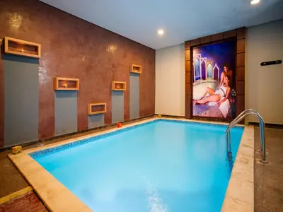 a pool in a hotel room with a painting on the wall at Pickalbatros Aqua Fun Club All Inclusive in Marrakech