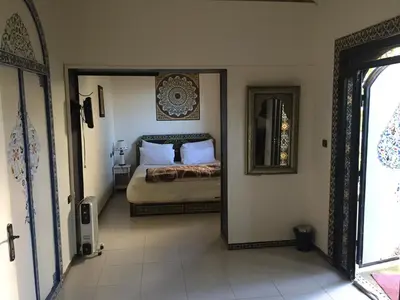 a bedroom with a bed and a mirror on the wall at Flashback House in Marrakech
