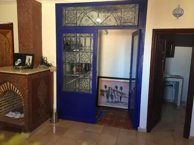 a room with a blue door with a wine rack at Flashback House in Marrakech