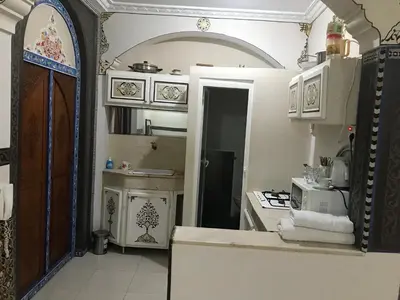 a kitchen with an open door to a kitchen with a stove at Flashback House in Marrakech