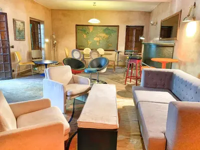 a room with couches and chairs and tables at Riad Rockech in Marrakech