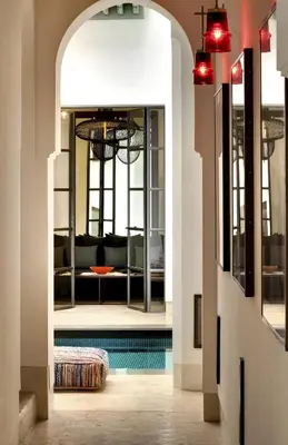 a hallway with a pool and a living room at Riad Antara in Marrakech