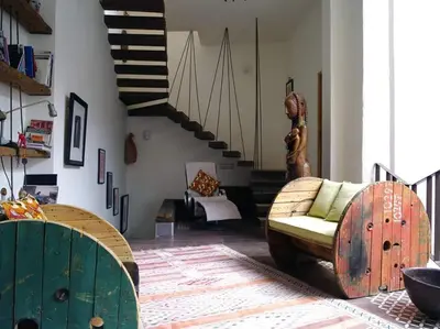 a living room with a couch and a staircase at Dar d'Art in Marrakech