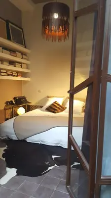 a bedroom with a bed and a glass door at Dar d'Art in Marrakech