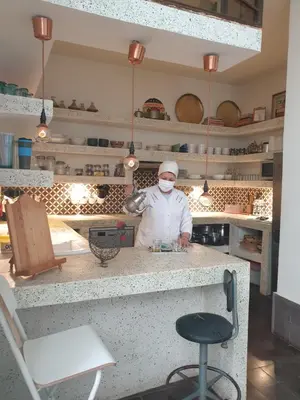 a chef standing in a kitchen with a mask on at Dar d'Art in Marrakech