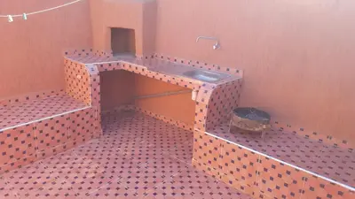 a bathroom with a sink in a tiled floor at Riad Naim in Marrakech