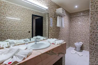 a bathroom with a sink and a toilet at Hotel Meriem Marrakech in Marrakech