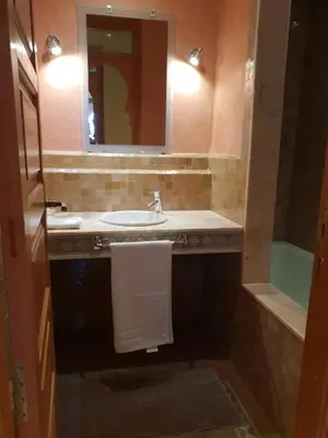 a bathroom with a sink and a mirror and a tub at Palmeraie village 2 , les jardins de la palmeraie 2 in Marrakech
