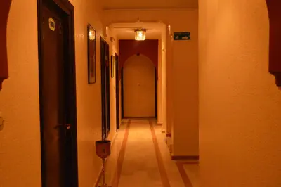 a hallway with a long corridor with a long hallway at Hotel Amalay in Marrakech