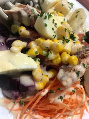 a plate of food with corn and other vegetables at Hotel Tachfine in Marrakech