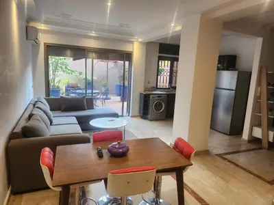 a living room with a couch and a table at Appartement Centre Gueliz Hanane in Marrakech