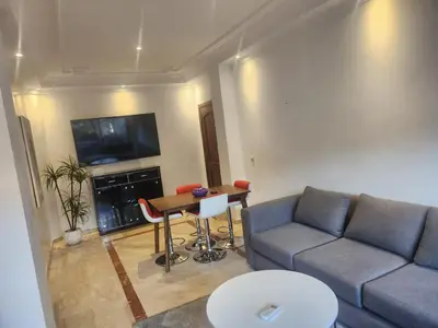 a living room with a couch and a table at Appartement Centre Gueliz Hanane in Marrakech