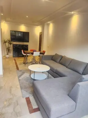 a living room with a couch and a table at Appartement Centre Gueliz Hanane in Marrakech