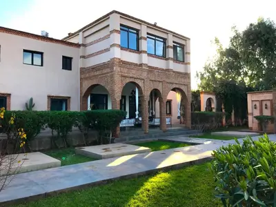 a house with a garden in front of it at Palais Souad in Marrakech